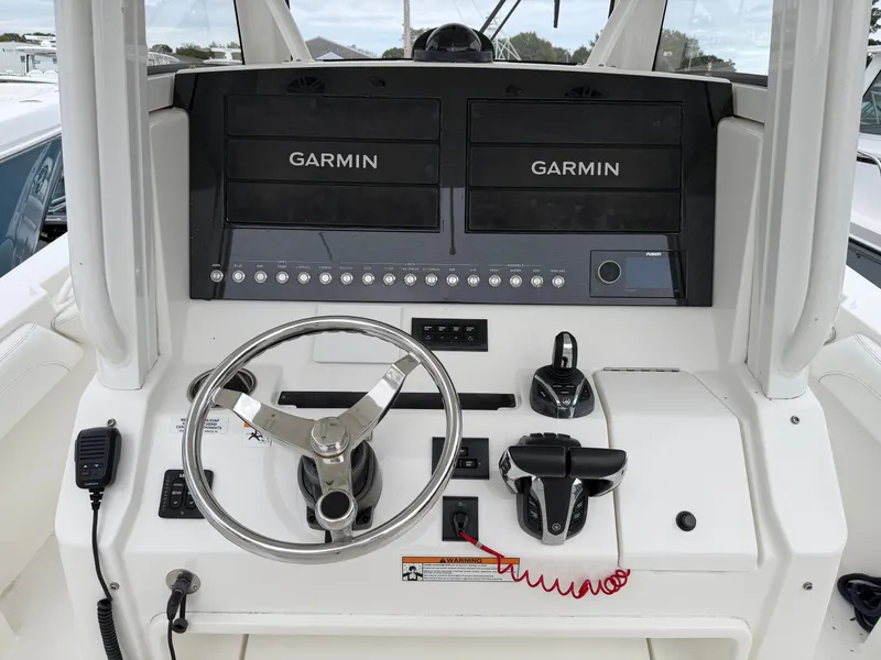 Slide: The Image of The image shows the helm of a Regulator 28 boat with Garmin screens and controls. - 22