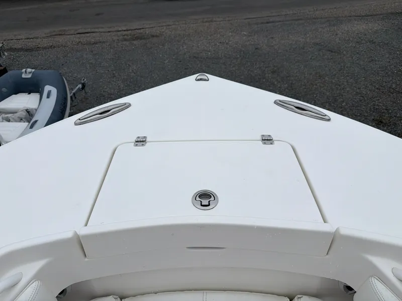 Slide: The Image of The bow of a white boat with hatches and a latch. - 34