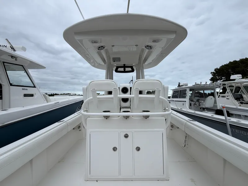 Slide: The Image of The image shows the cockpit of a 2021 Regulator 28 boat with white seating and storage. - 17