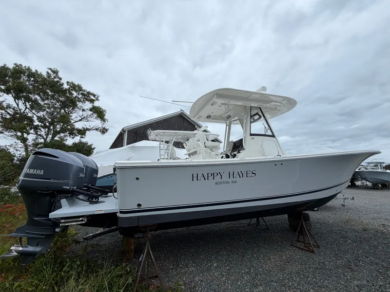 Slide: The Image of A 2021 Regulator 28 boat on dry dock, featuring twin Yamaha engines. - 8