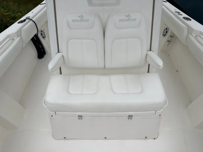 Slide: The Image of 2021 Regulator 28 with white cushioned seats and armrests in the cockpit area. - 38