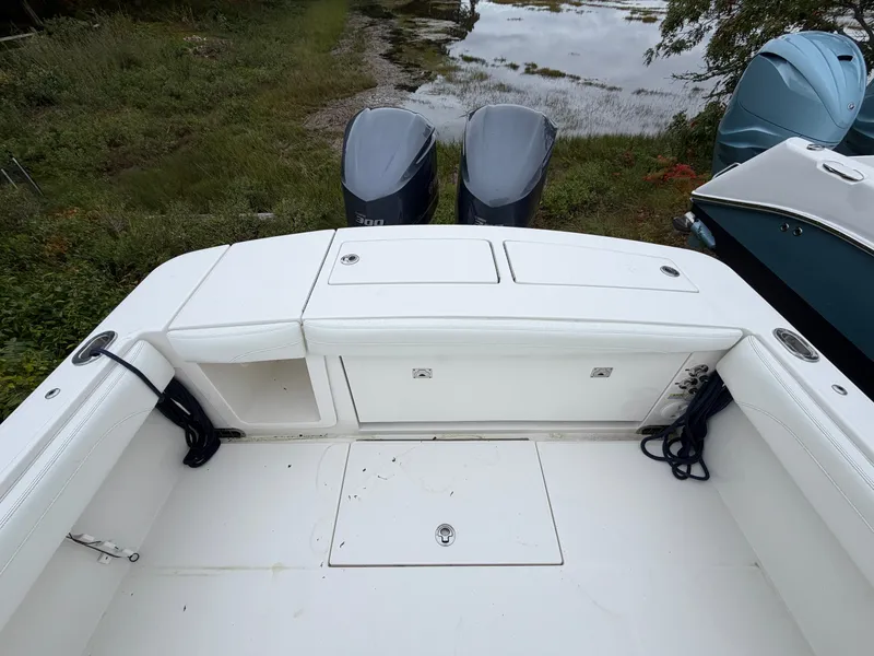 Slide: The Image of The image shows the stern of a Regulator 28 boat with two outboard engines. - 14