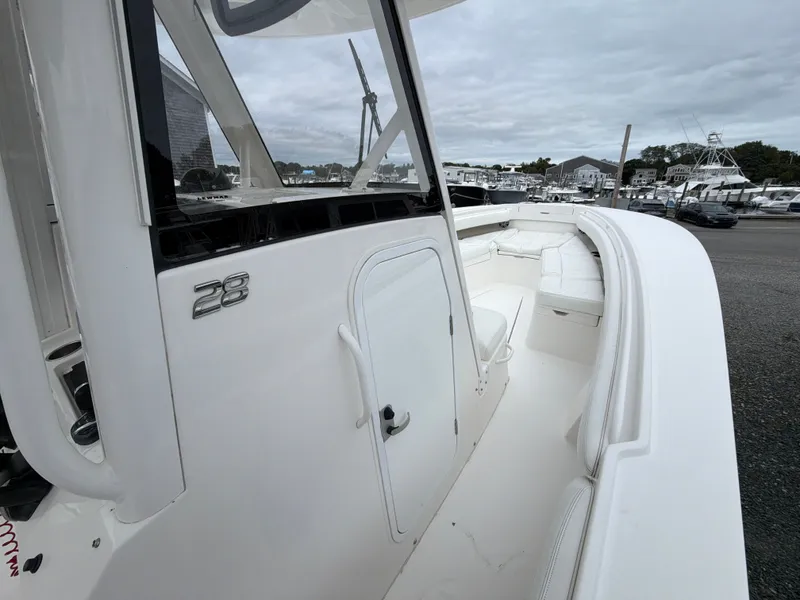 Slide: The Image of 2021 Regulator 28 at the dock, featuring a clean white deck and clear windshield. - 30