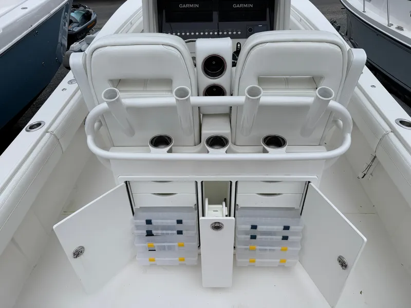 Slide: The Image of The image shows the cockpit of a Regulator 28 boat with rod holders and storage compartments. - 18