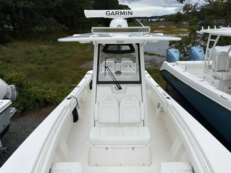 Slide: The Image of 2021 Regulator 28 with Garmin equipment, white interior, spacious deck, parked outdoors. - 37