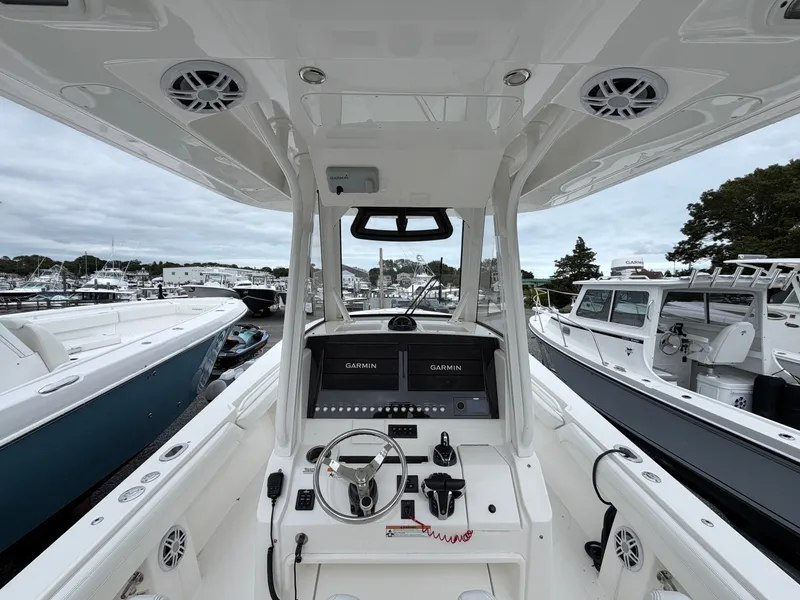 Slide: The Image of The cockpit of a 2021 Regulator 28 boat with modern Garmin displays. - 21