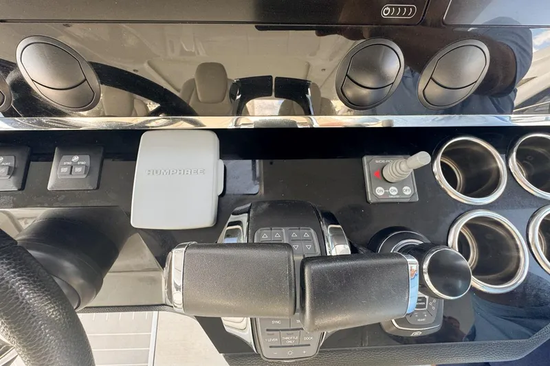 Slide: The Image of Control panel of 2023 Azimut Verve 47 yacht with steering and throttle controls. - 46
