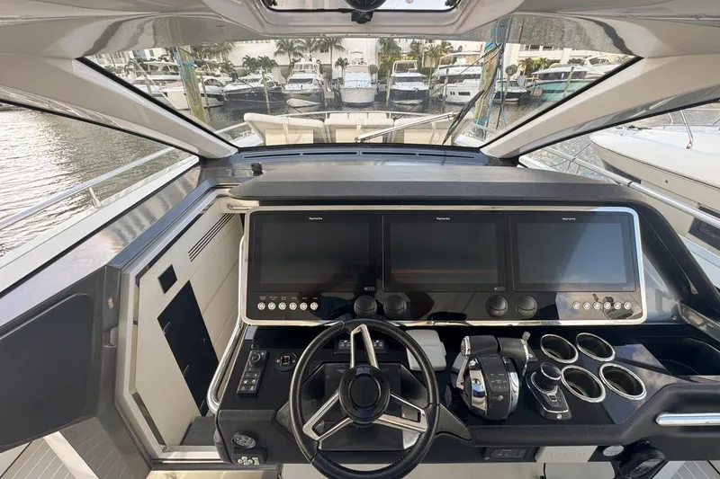 Slide: The Image of 2023 Azimut Verve 47 yacht cockpit with modern navigation screens and controls. - 35