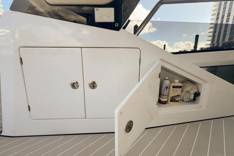 Slide: The Image of 2023 Azimut Verve 47 yacht storage compartment with cleaning supplies on deck. - 32