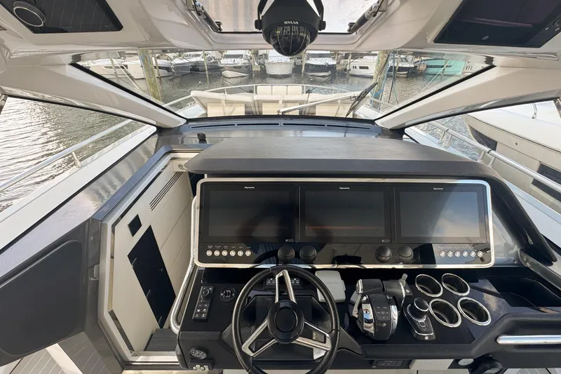 Slide: The Image of 2023 Azimut Verve 47 yacht cockpit with advanced navigation displays and controls. - 34