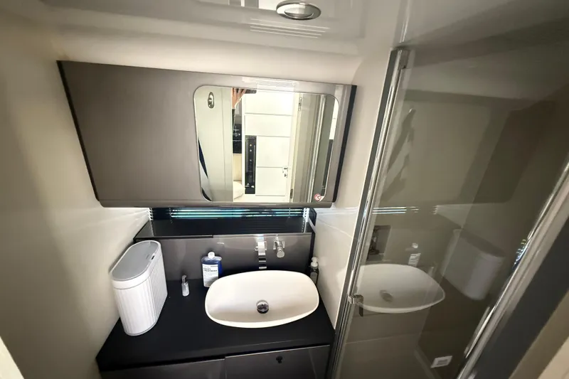 Slide: The Image of Modern bathroom interior of 2023 Azimut Verve 47 yacht, featuring sleek sink and mirror. - 100
