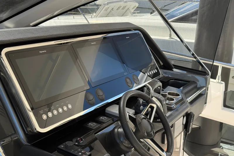 Slide: The Image of 2023 Azimut Verve 47 yacht helm with advanced navigation displays and controls. - 40