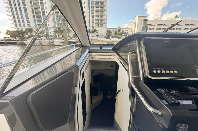 Slide: The Image of 2023 Azimut Verve 47 yacht interior with control panel, docked near modern buildings. - 39