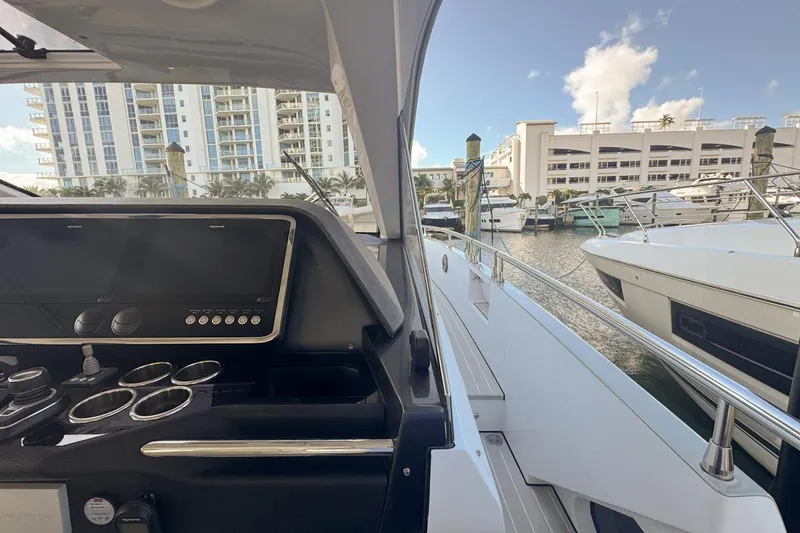 Slide: The Image of 2023 Azimut Verve 47 yacht docked at marina, modern helm, luxury setting. - 44
