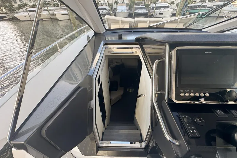 Slide: The Image of 2023 Azimut Verve 47 yacht interior with control panel and cabin entrance. - 37