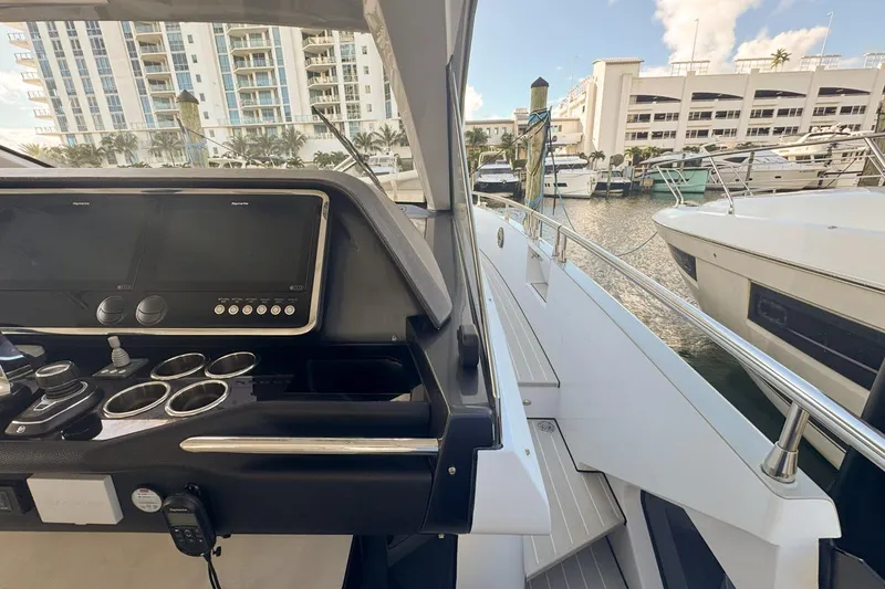 Slide: The Image of Cockpit view of 2023 Azimut Verve 47 yacht docked at marina. - 43