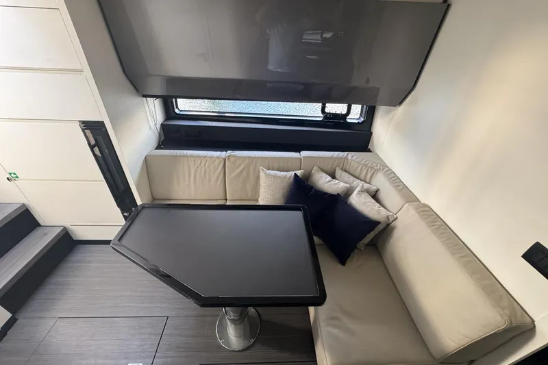 Slide: The Image of Luxurious interior of 2023 Azimut Verve 47 yacht with modern seating and table. - 79