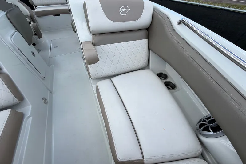 Slide: The Image of 2023 Crownline Eclipse E235 XS boat interior with cushioned seating and cup holders. - 50