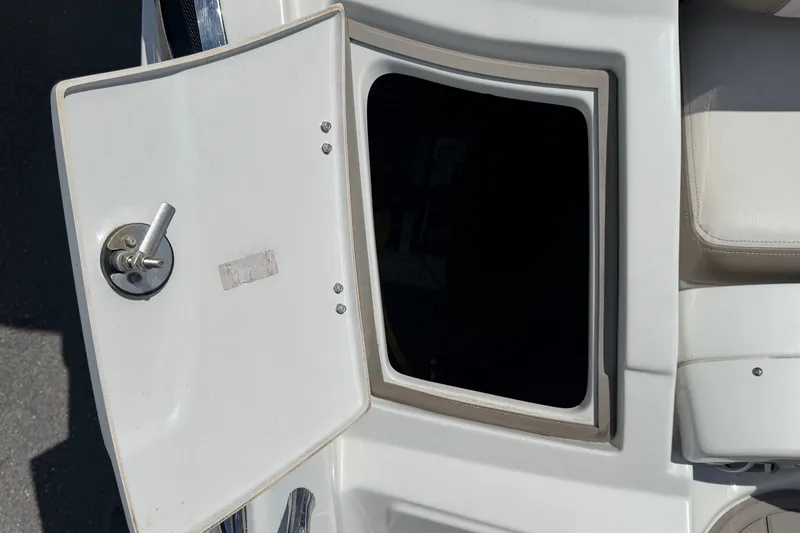 Slide: The Image of An open storage compartment on a 2023 Crownline Eclipse E235 XS boat. - 15