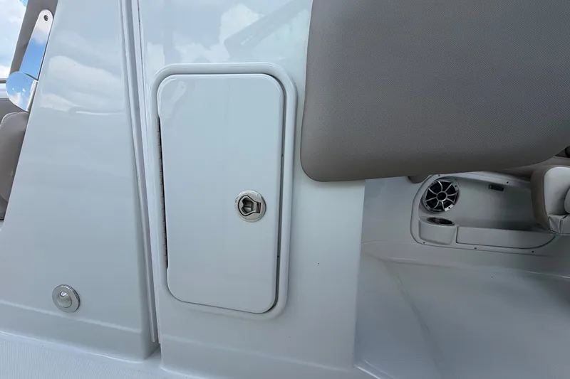 Slide: The Image of 2023 Crownline Eclipse E235 XS boat interior storage compartment and speaker detail. - 42