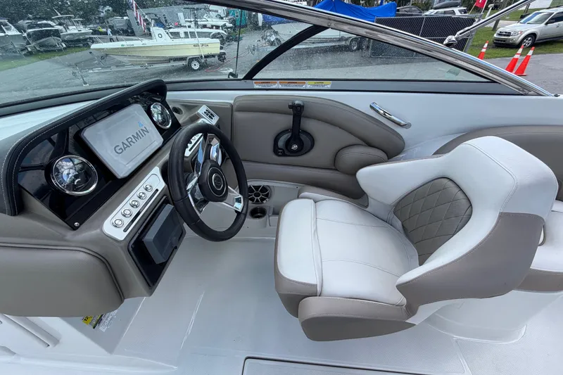 Slide: The Image of 2023 Crownline Eclipse E235 XS boat interior with Garmin navigation system and luxurious seating. - 28