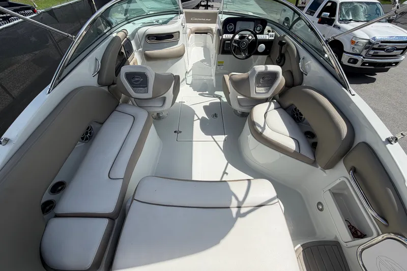 Slide: The Image of 2023 Crownline Eclipse E235 XS boat interior with plush seating and modern dashboard. - 18