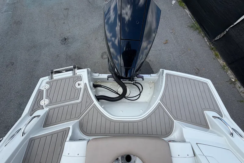 Slide: The Image of 2023 Crownline Eclipse E235 XS boat stern with outboard motor and swim platform. - 73