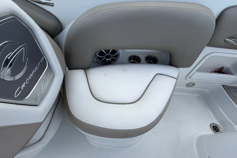 Slide: The Image of 2023 Crownline Eclipse E235 XS boat interior with cushioned seating and cup holders. - 62