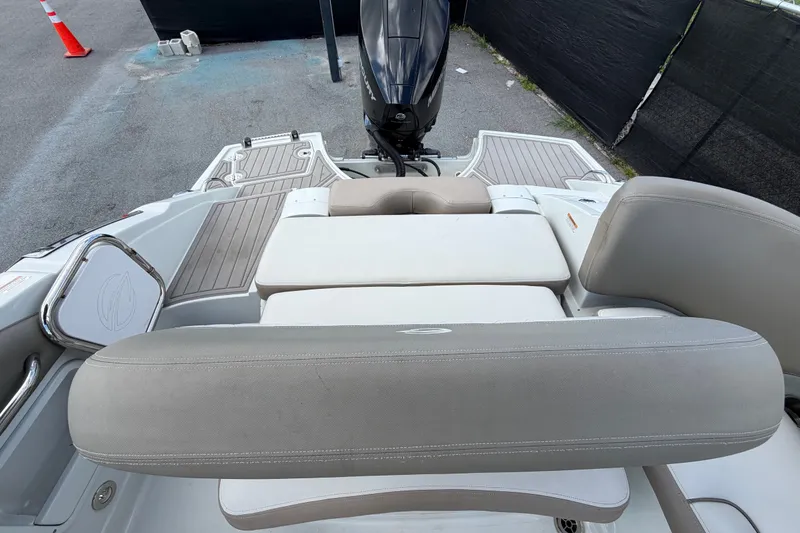 Slide: The Image of 2023 Crownline Eclipse E235 XS boat interior with seating and motor view. - 70