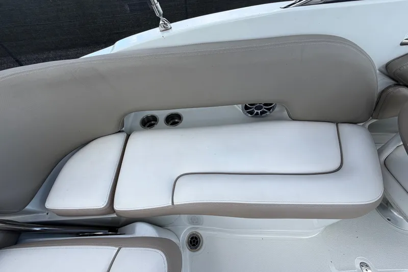 Slide: The Image of 2023 Crownline Eclipse E235 XS boat interior seating with cup holders and speaker. - 66