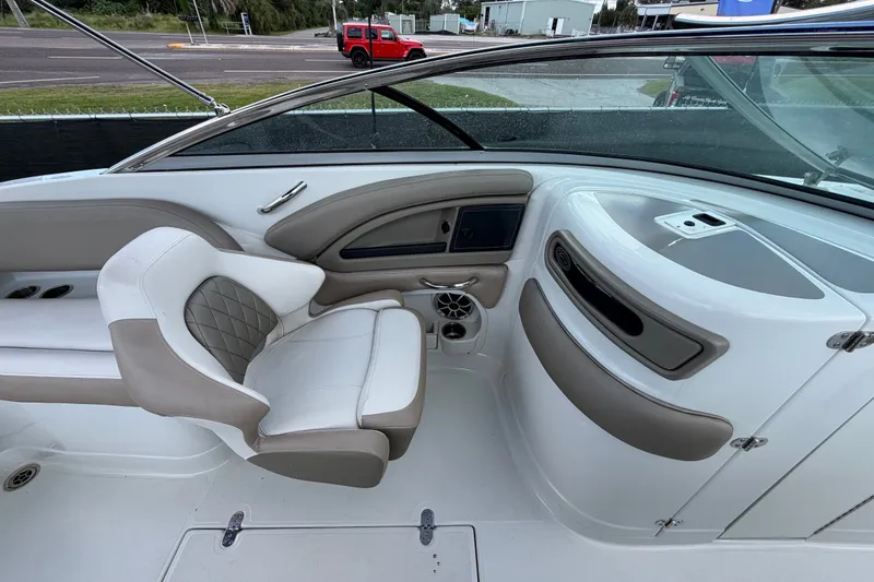 Slide: The Image of 2023 Crownline Eclipse E235 XS boat interior with white and beige seating. - 24