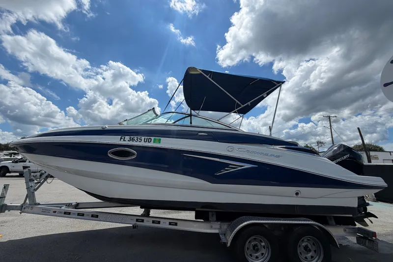 Slide: The Image of 2023 Crownline Eclipse E235 XS boat on trailer under blue sky. - 8