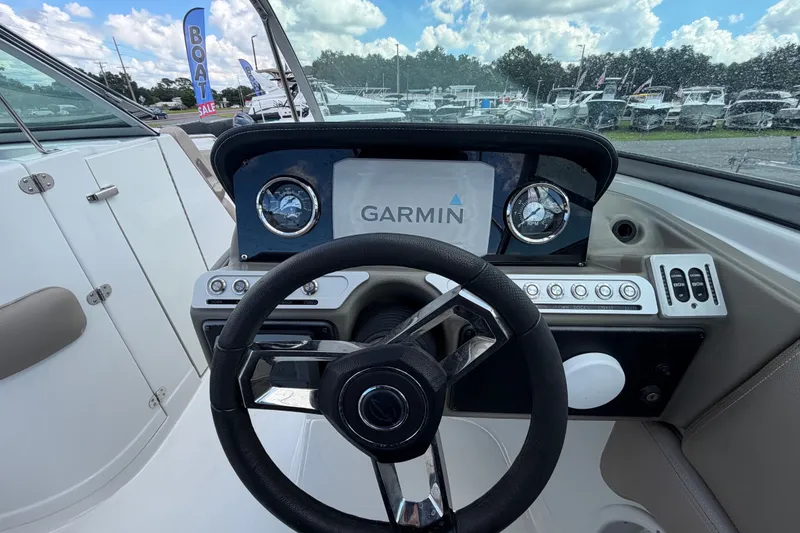 Slide: The Image of 2023 Crownline Eclipse E235 XS dashboard with Garmin display and steering wheel. - 31