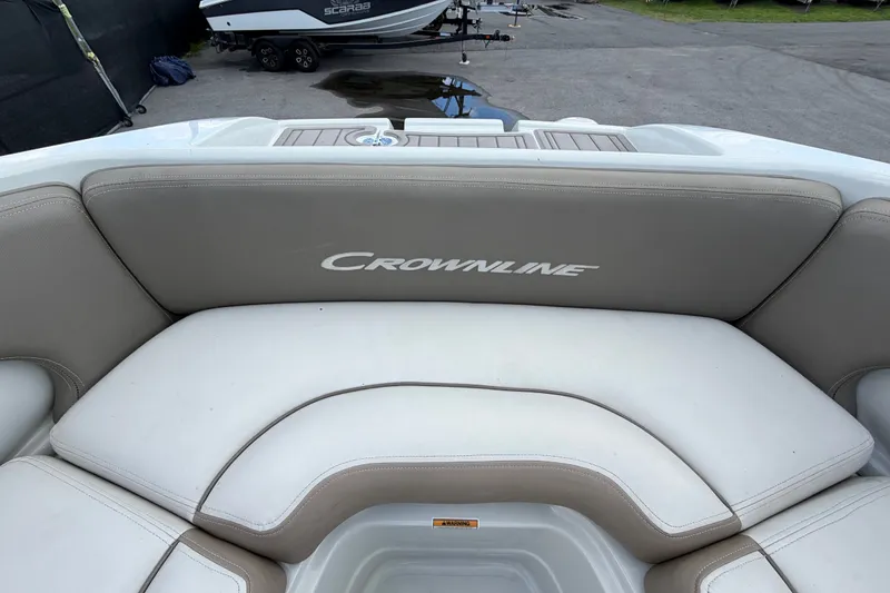 Slide: The Image of 2023 Crownline Eclipse E235 XS boat interior with cushioned seating. - 46