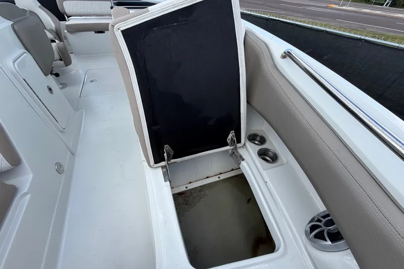 Slide: The Image of 2023 Crownline Eclipse E235 XS boat interior with open storage compartment. - 51