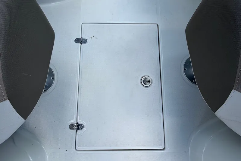 Slide: The Image of The image shows a floor hatch between two seats on a boat. - 21