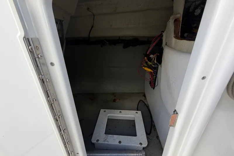 Slide: The Image of Interior view of 2023 Crownline Eclipse E235 XS boat compartment with wiring visible. - 43