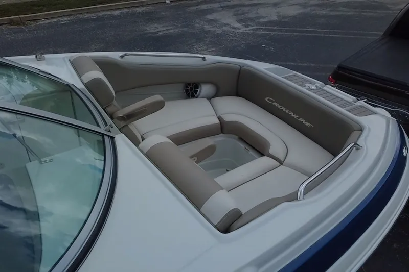 Slide: The Image of 2023 Crownline Eclipse E235 XS boat interior with beige seating and sleek design. - 15