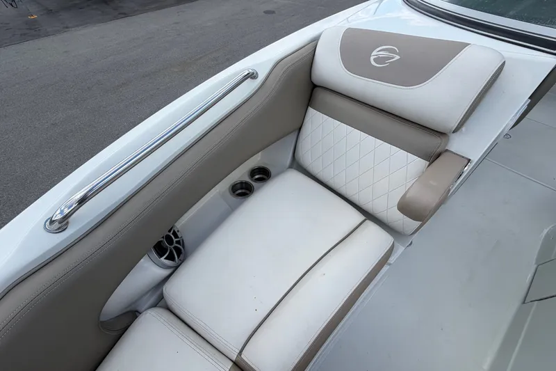 Slide: The Image of 2023 Crownline Eclipse E235 XS boat interior with cushioned seating and cup holders. - 52