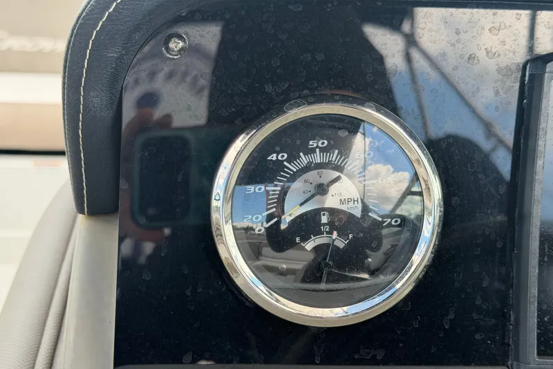 Slide: The Image of Speedometer and fuel gauge on 2023 Crownline Eclipse E235 XS boat dashboard. - 36