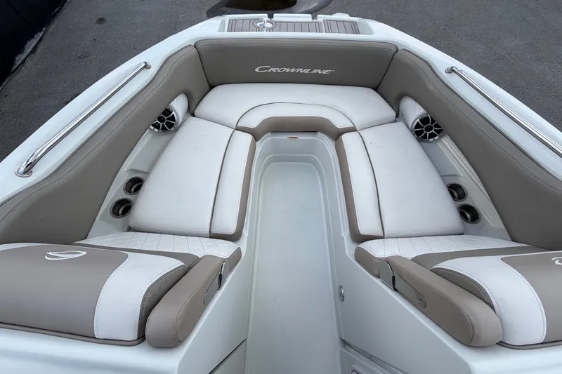 Slide: The Image of The image shows the bow area of a Crownline Eclipse E235 XS boat with beige and white upholstery. - 44