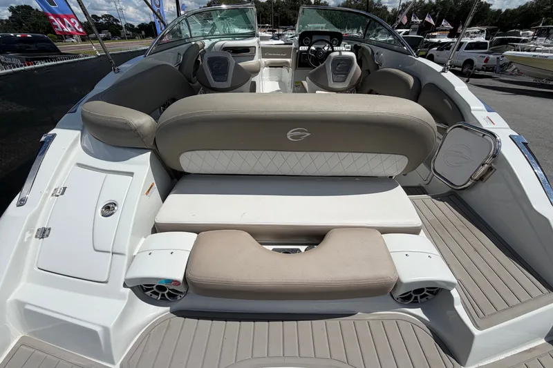 Slide: The Image of 2023 Crownline Eclipse E235 XS boat interior with beige seating and modern dashboard. - 13
