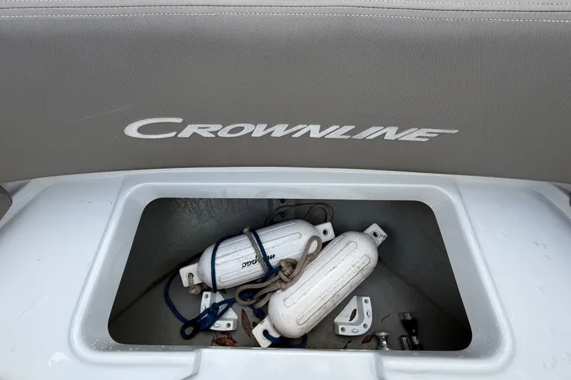 Slide: The Image of 2023 Crownline Eclipse E235 XS boat storage compartment with fenders and ropes. - 47