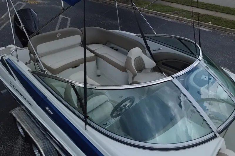 Slide: The Image of 2023 Crownline Eclipse E235 XS boat with spacious seating and sleek design. - 14