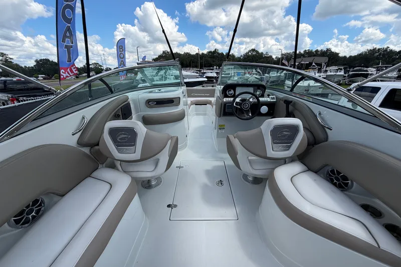 Slide: The Image of 2023 Crownline Eclipse E235 XS boat interior with plush seating and modern dashboard. - 19