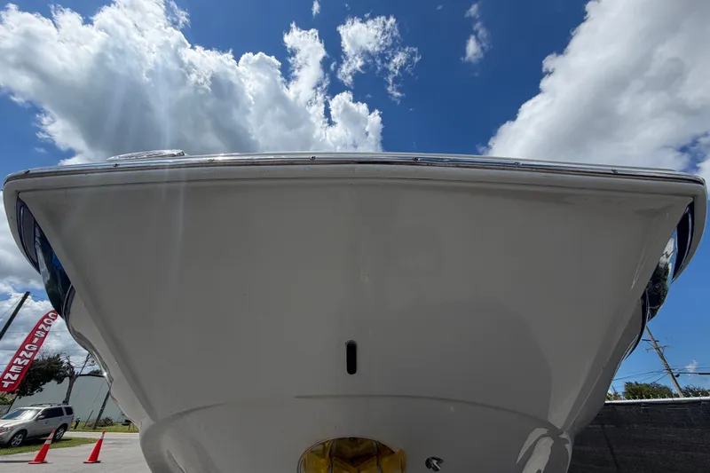 Slide: The Image of 2023 Crownline Eclipse E235 XS boat under a bright blue sky with clouds. - 10