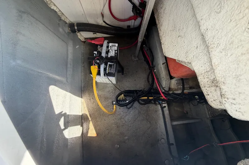 Slide: The Image of View of a boat's engine compartment with cables and a battery. - 16