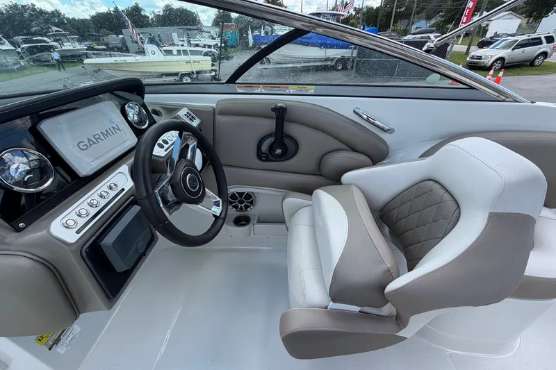 Slide: The Image of 2023 Crownline Eclipse E235 XS boat interior with Garmin navigation system and luxurious seating. - 29