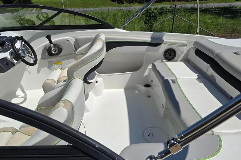Slide: The Image of 2018 Tahoe 700 boat interior with white seating and steering wheel. - 14