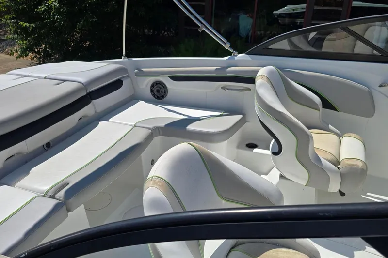 Slide: The Image of Interior of a 2018 Tahoe 700 boat with white and green seating. - 10